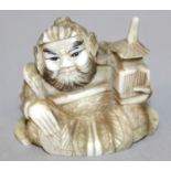 A SIGNED 19TH/20TH CENTURY JAPANESE CARVED IVORY NETSUKE OF SHOKI, 1.6in wide.