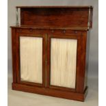 A REGENCY ROSEWOOD CHIFFONIER, the upper section supported by a pair of brass columns over a