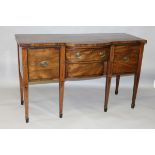 A GEORGE III MAHOGANY SIDEBOARD, with bow front central drawer, above a further drawer, flanked by a