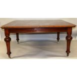 A VICTORIAN MAHOGANY EXTENDING DINING TABLE, with rounded rectangular top, two leaves on turned