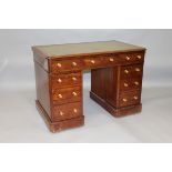 A 19TH CENTURY MAHOGANY PEDESTAL DESK with rounded rectangular top, green leather inset writing