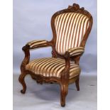 A VICTORIAN ARMCHAIR IN THE FRENCH TASTE, with carved show wood frame, pink striped upholstered