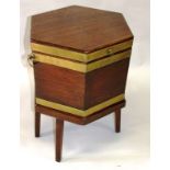 A REGENCY MAHOGANY OCTAGONAL BRASS BOUND WINE COOLER with rising top, three brass bands on a stand