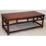 A CHINESE ROSEWOOD LOW RECTANGULAR TABLE with openwork frieze, turned legs united by flattened