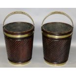 A PAIR OF IRISH MAHOGANY PEAT BUCKETS with brass handles and brass bands.