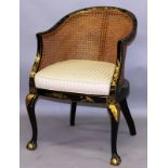 A BLACK LACQUER AND GILT DECORATED BERGERE STYLE ARMCHAIR on cabriole legs with claw and ball feet.