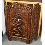 A GOOD CHINESE CARVED TRIPLE FOLDING SCREEN carved with dragons and motifs. 3ft high, 3ft 4ins