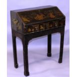 A REGENCY BLACK LACQUER AND CHINOISERIE DECORATED BUREAU, the flap opening to reveal small drawers