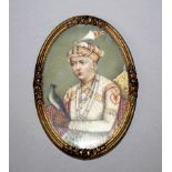 A FINE QUALITY 19TH CENTURY GILT-METAL FRAMED OVAL INDIAN PAINTING ON IVORY OF A MAHARAJA, dressed