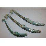 THREE GOOD QUALITY ARCHAIC STYLE SILVER-METAL INLAID BRONZE BUCKLES, each decorated with stylised