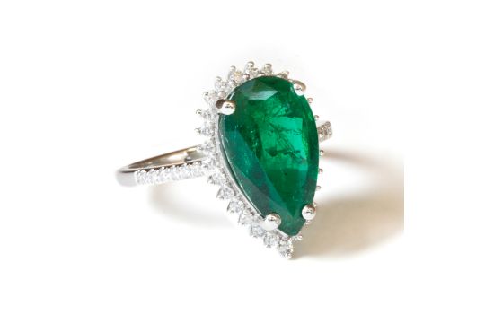 A 5.92 carat natural and untreated pear cut Emerald, set in an 18 carat white gold ring and - Image 1 of 3