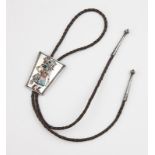 An inlaid silver kachina bolo tie, Bennett Circa mid-20th century, impressed fleur-de-lis mark,
