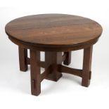 An oak Arts and Crafts dining table Early 20th century, apparently unsigned, the outset circular top