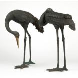 Two large Japanese bronze crane sculptures 20th century, each freestanding cast bronze crane with