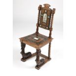 An Italian Renaissance-style hall chair Late 18th/early 19th century, of walnut carved and all-