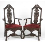 A pair of Continental carved wood armchairs Late 19th/early 20th century, each of oak, with