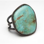 1076  A Native American oversized turquoise cuff  The single oversized turquoise cabochon