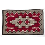 1087  A Navajo hand-woven regional rug Circa 1930s, with a central stepped diamond centering a