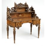 1026  German ornately carved and marquetry inlaid desk Second half 19th century, surmounted by a