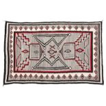 1086  A Navajo regional room-sized rug First half 20th century, gray field with red, black and cream