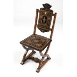 1063  An Italian inlaid hall chair 19th century, of walnut construction, carved and all-over