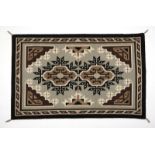 1104  A Navajo Two Grey Hills Rug, Violet Brown Late 20th century, a hand-woven woolen rug featuring