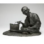 1050 A Japanese bronze figural sculpture Meiji period (1868-1911), signed to base, depicting a