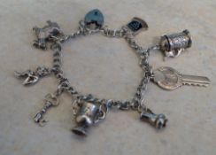 White metal charm bracelet, including 9 charms, only 3 marked as Silver