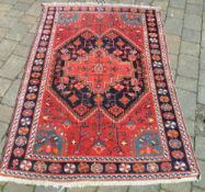 Red patterned rug 110 x 165 cm