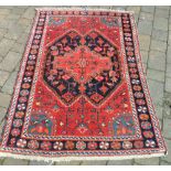 Red patterned rug 110 x 165 cm