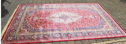 Red ground Kashmir carpet with a traditi