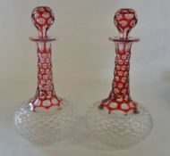 Pair of cranberry cut glass decanters