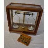 Cased set of balanced scales with a set