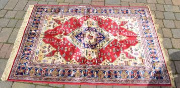Red ground Kashmir rug with Aztec design
