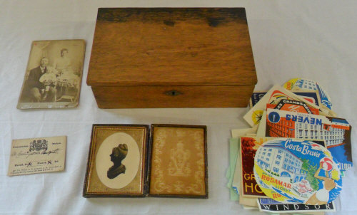 Wooden box containing old luggage sticke