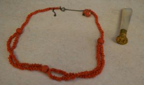 Coral necklace and a brass seal stamp wi