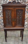 Late Victorian carved oak cabinet on a s