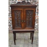 Late Victorian carved oak cabinet on a s