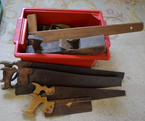 Old tools including a wood plane, hand s