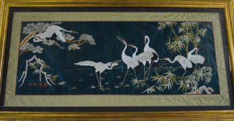 Oriental framed silk depicting storks