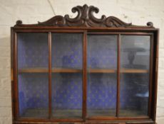 Display cabinet with carved pediment