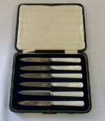 Cased set of silver butter knives with m