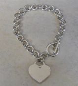 Silver bracelet with heart pendant weigh