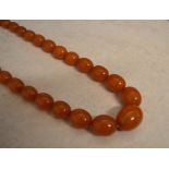 String of graduated egg yolk amber beads