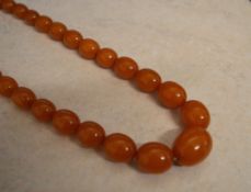 String of graduated egg yolk amber beads