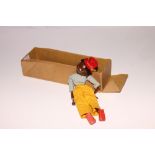 A Pelham puppet of a coloured girl wearing a blue top and yellow trousers (lacks control bar and