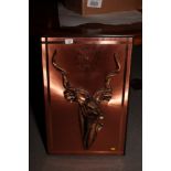 A copper wall panel decorated antelope head and clock