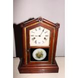 A late 19th Century American mantel clock with eight-day striking movement and floral decorated