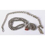 A silver watch chain and a silver bracelet mounted with a fob seal and locket