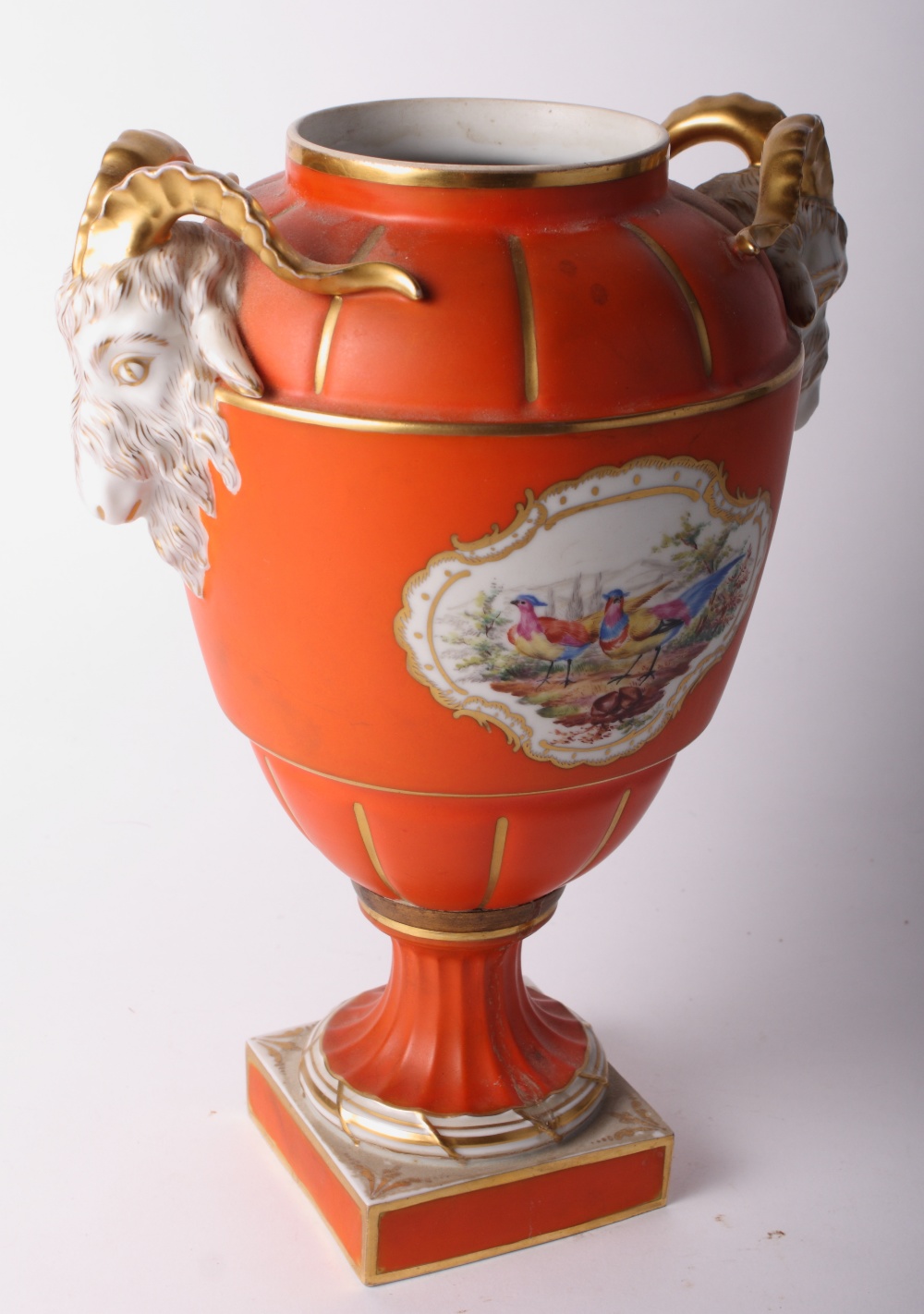 A Dresden porcelain vase with orange and gilt decorated body painted floral reserves and gilt ram'